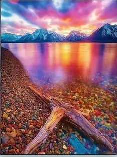 Colourful reflection on lake with pebbles